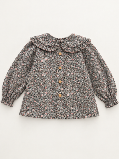 Blusa de niña con flores y cuello redondo